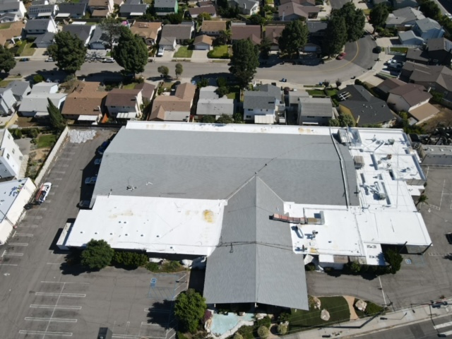 Flat white commercial roof with rooftop units