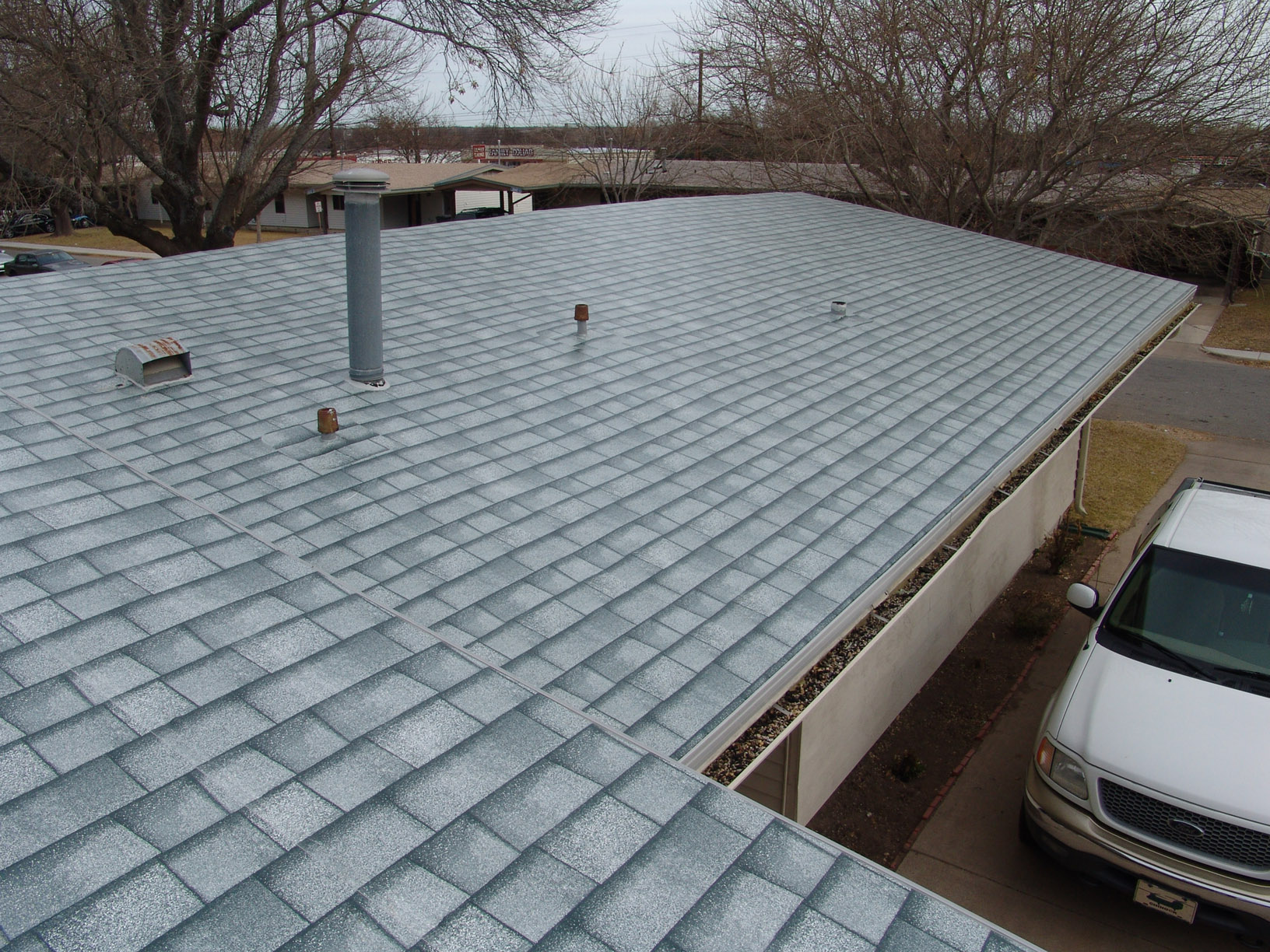 Residential roof with shingle and ply system